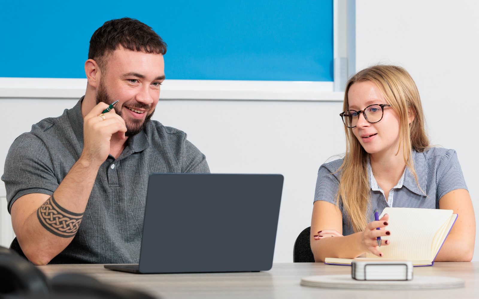 Team members reviewing work together in a meeting room